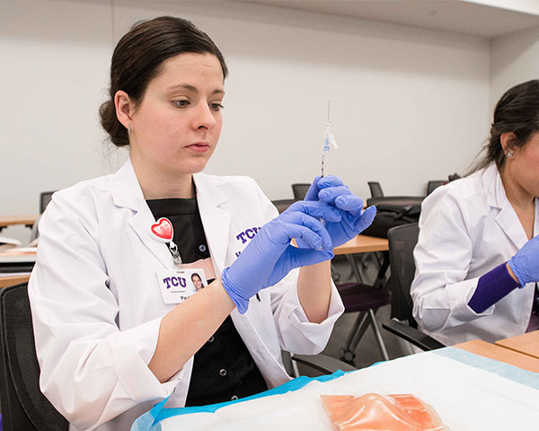 A TCU nursing student in a wound care class
