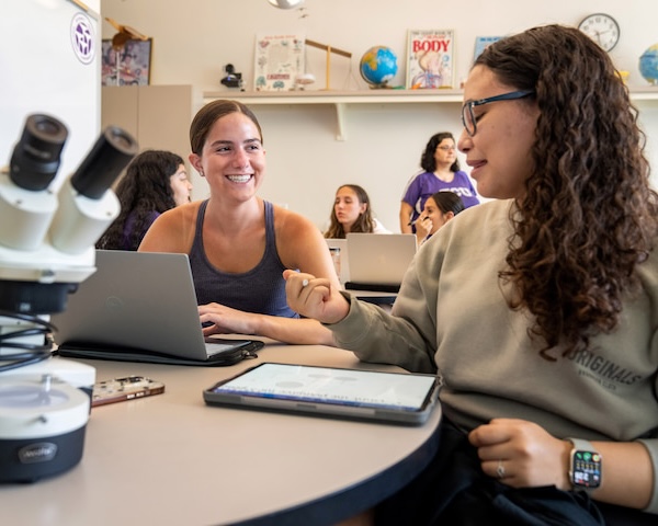 Two students sitting at a table in a science education class