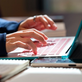 Student typing on laptop