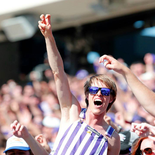 Student fan in striped overalls