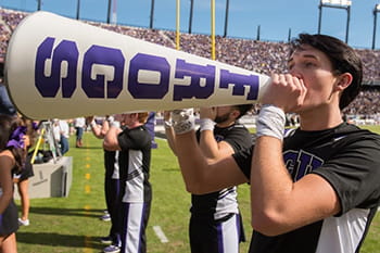 TCU yell leader holding megaphone