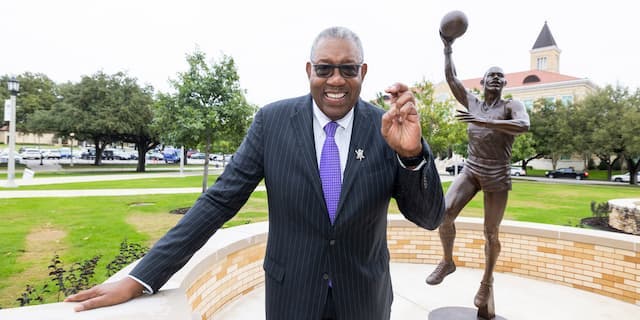 James Cash stands in front of his statue