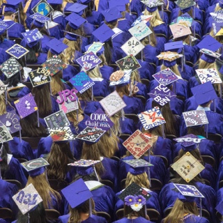 Overhead view of TCU nursing graduates' decorated caps at Commencement