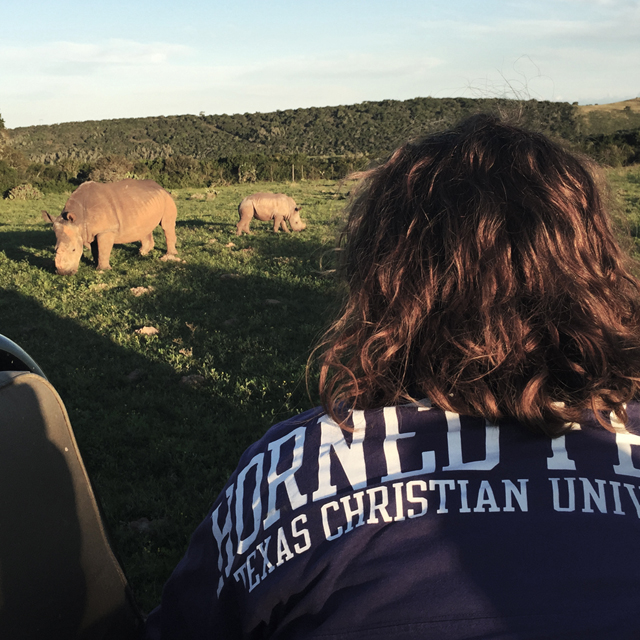 A TCU student observes a white rhino family in South Africa