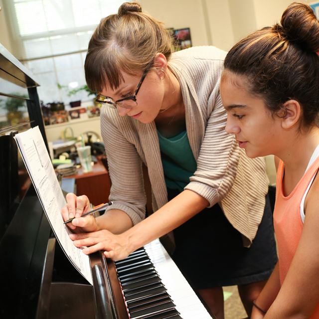 Teacher and student at piano