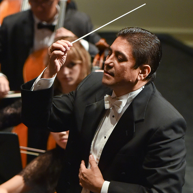 German Gutierrez conducting an orchestra