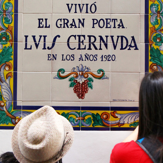 Students read a Spanish tile sign