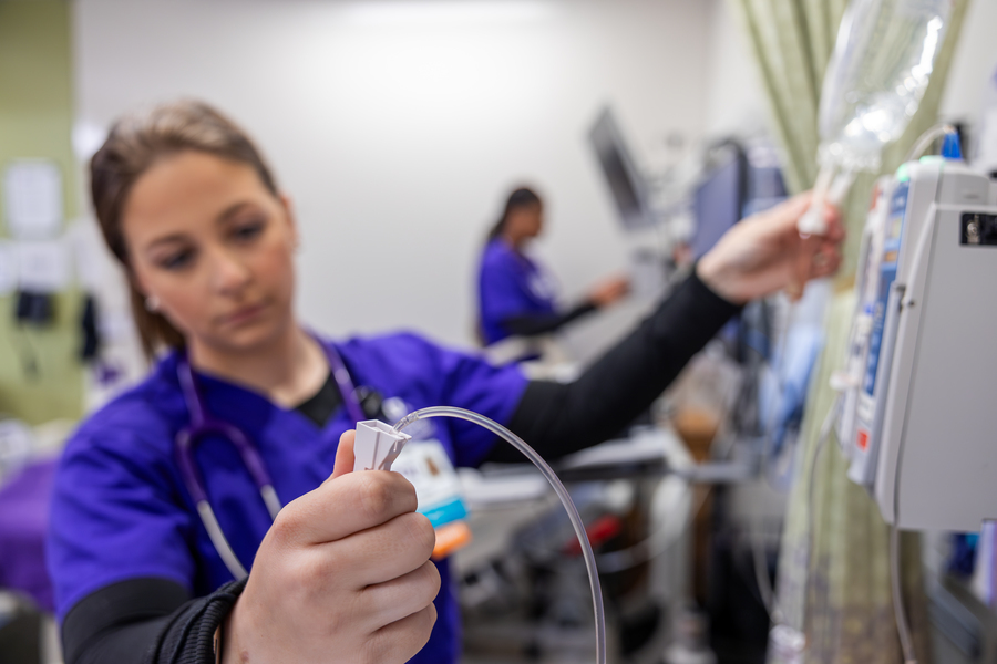nurse administering intravenous medication