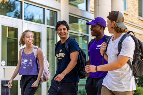 Four students walking on campus