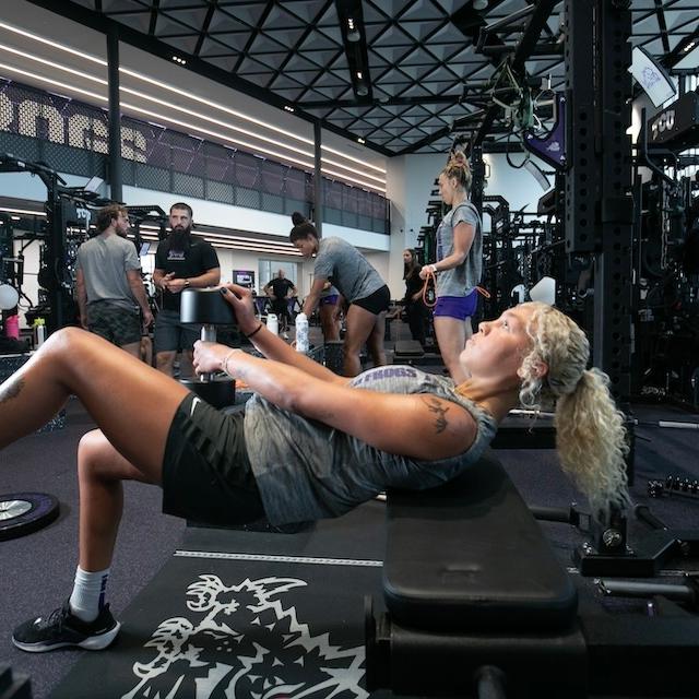 Student-athlete lifts weights