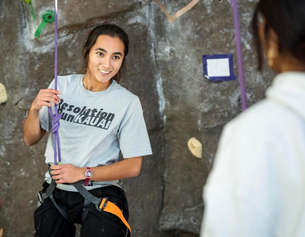 Students on campus sitting in the Commons