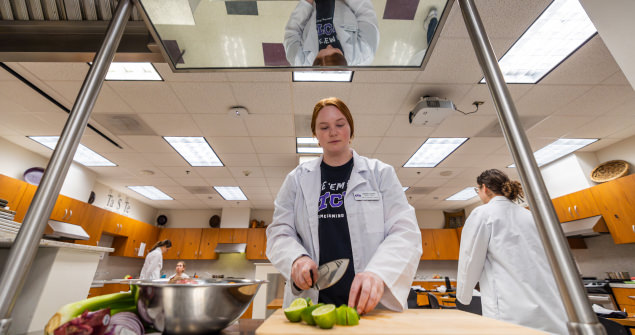 Students work in nutrition laboratory, preparing fruit