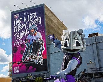 SuperFrog in front of a giant mural