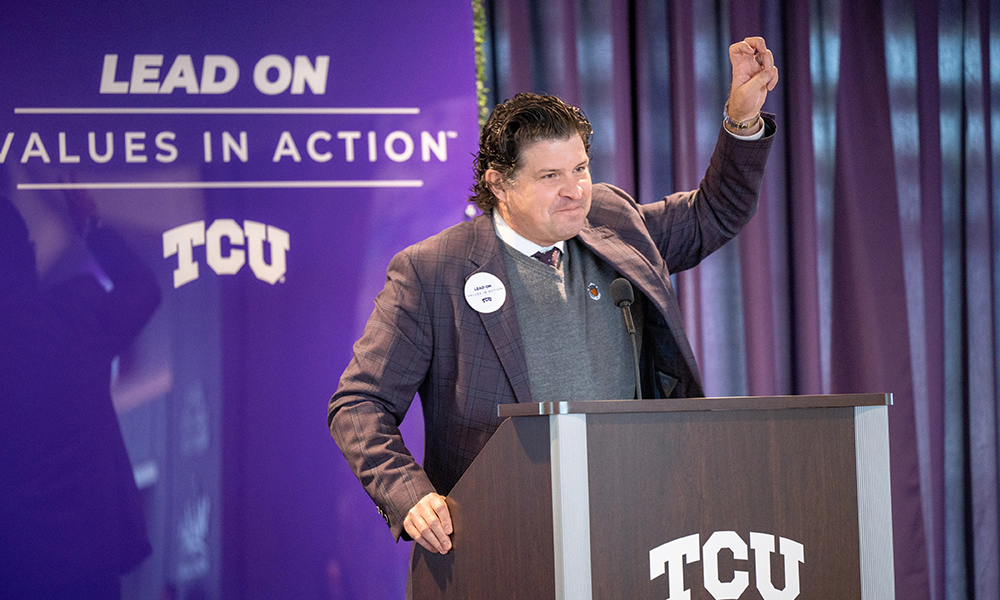 chancellor pullin behind a podium