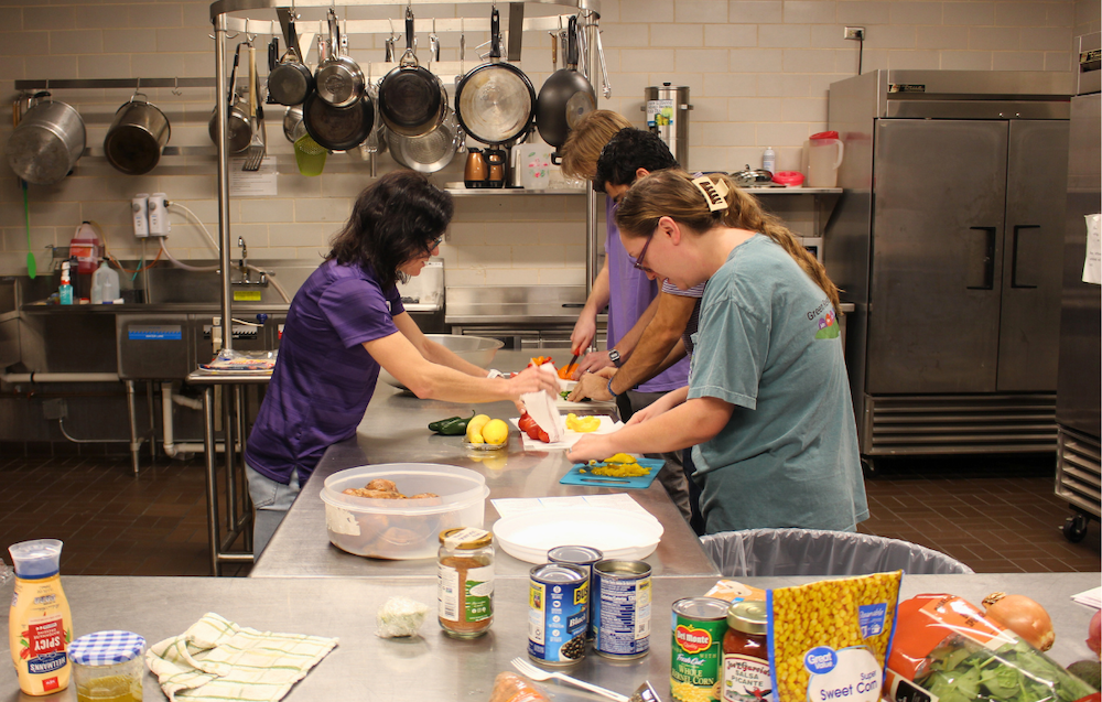 volunteers work in a kitchen