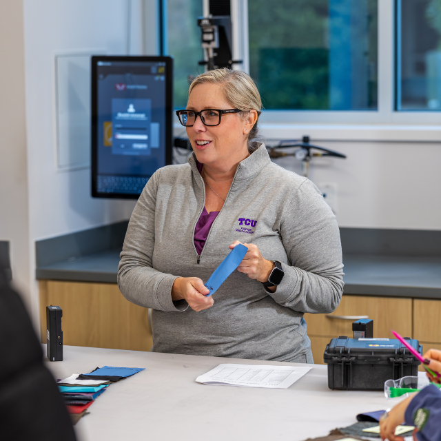 A professor holding a textile. 