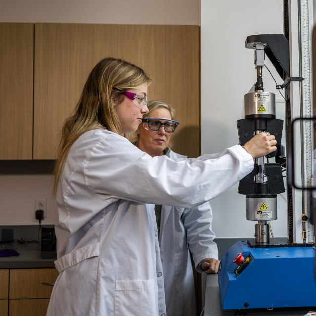 Student and professor work in a testing lab. 