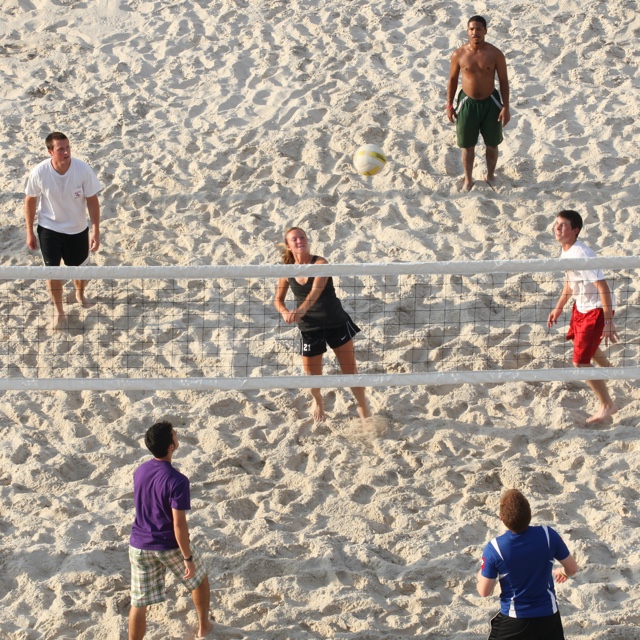 TCU students playing sand volleyball outside