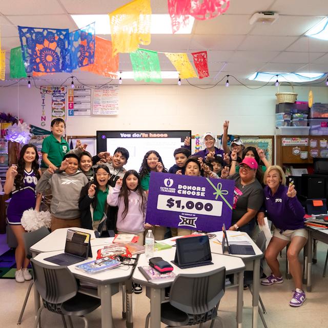 group of students receive check at Como Elementary