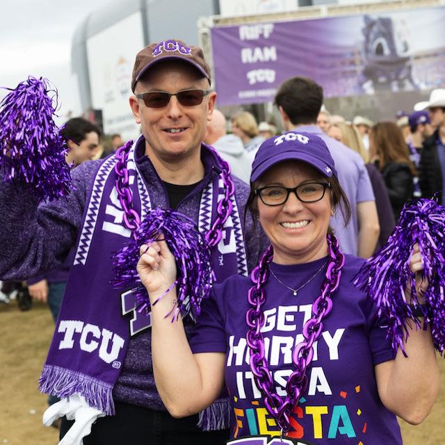 Two fans dressed in TCU fan gear get ready for the Fiesta Bowl