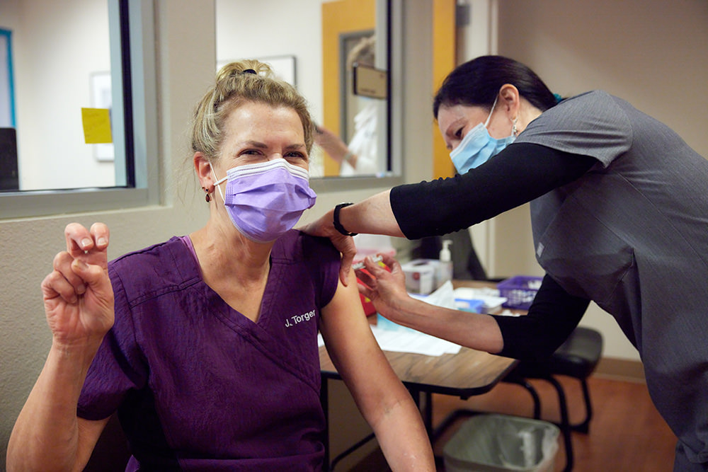 Jane Torgerson, M.D., receives her first dose of COVID-19 vaccine