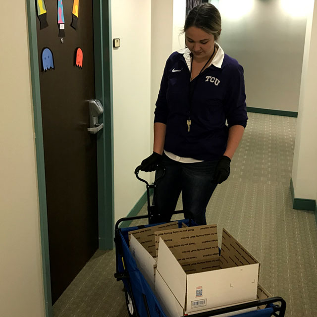 Photo of housing staff member gathering student supplies