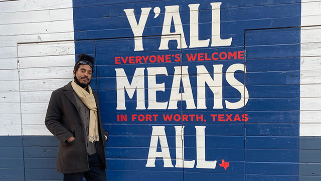 Dr. G standing in front of Fort Worth mural