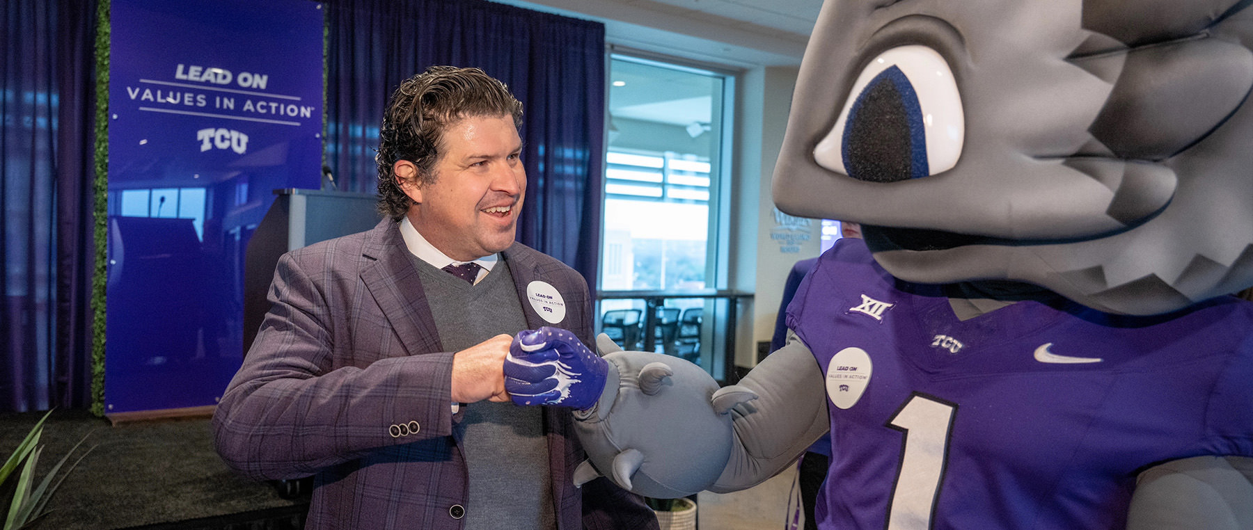 Daniel Pullin gives SuperFrog a fist bump