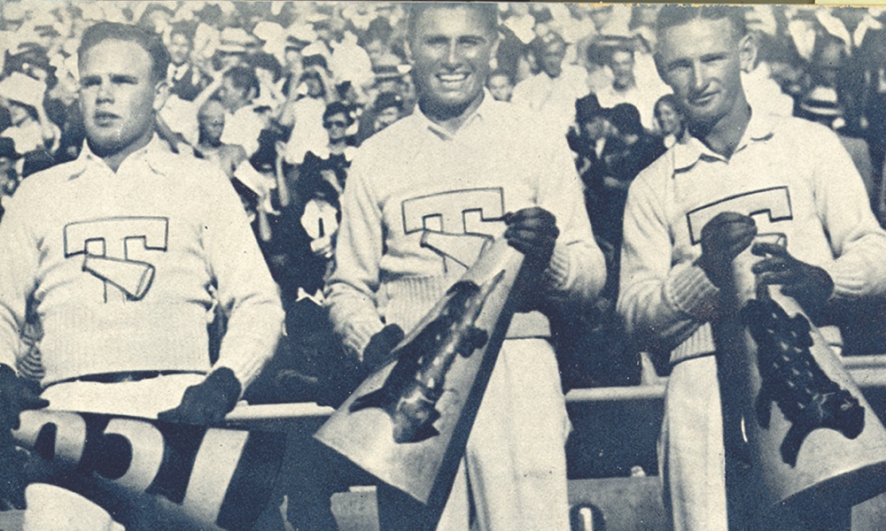 Yearbook photo of 1934 TCU Yell Leaders Three 1934 TCU male Yell Leaders smile holding megaphones