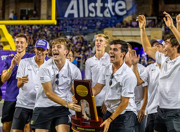 TCU men's tennis team holds up their NCAA championship trophy